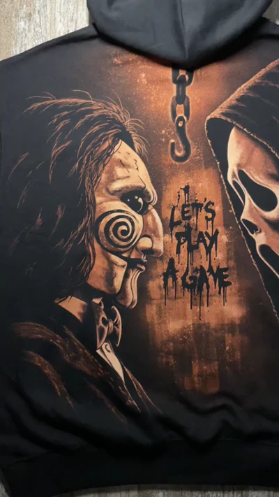 Close up video of the Ghostface and Billy the Puppet bleach artwork on a black horror hoodie