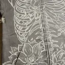 Video showing the first stage chalk sketch of skeleton and magnolia design on hoodie