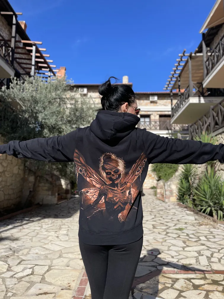 Full back view of a skeleton fairy bleach art hoodie worn by a model