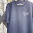 Daylight video showing the front of the t-shirt with artist logo and fairy wings