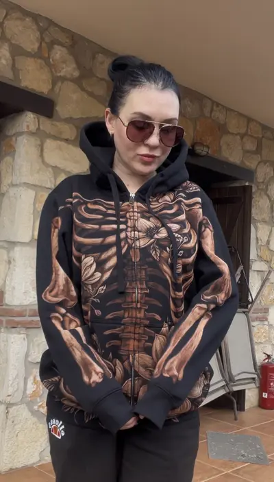 Model showing sleeve bone details on hand painted skeleton zip hoodie