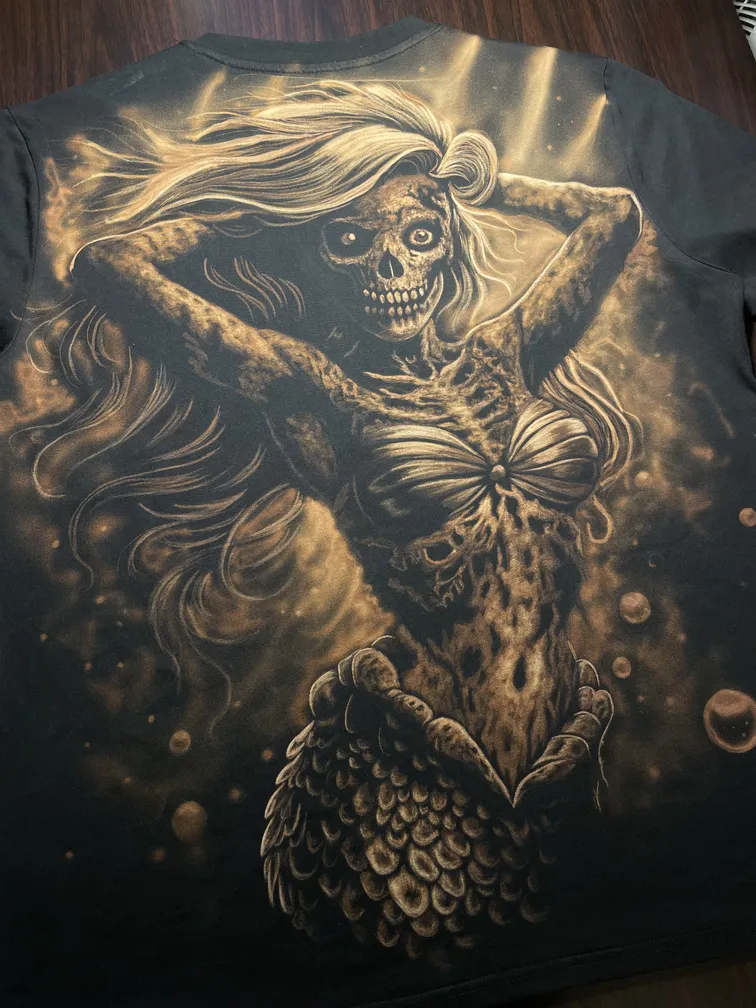 Skeleton mermaid bleach art illustration covering the back of a black t-shirt
