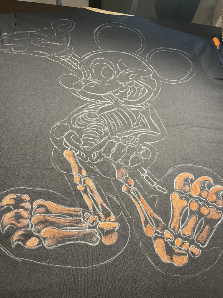 Early stage of a skeleton mouse illustration sketched on a t-shirt during the bleach art process