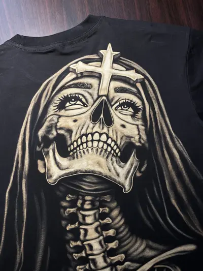Close-up detail of skeleton nun bleach art illustration on black cotton