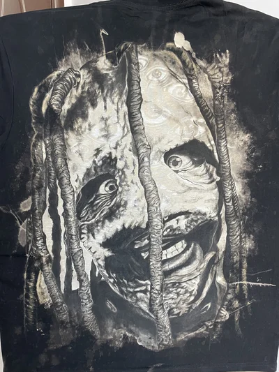 Close-up of the hand-painted Corey Taylor portrait with black textile paint and bleach details