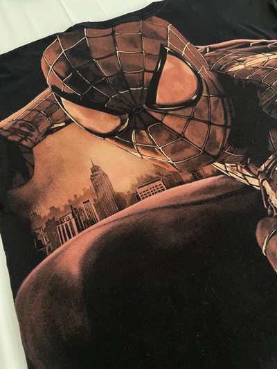 Angled back view of the oversized Spider-Man T-shirt with a hand-painted bleach design