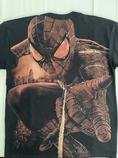 Full back view of an oversized black Spider-Man T-shirt with a large hand-painted bleach art design