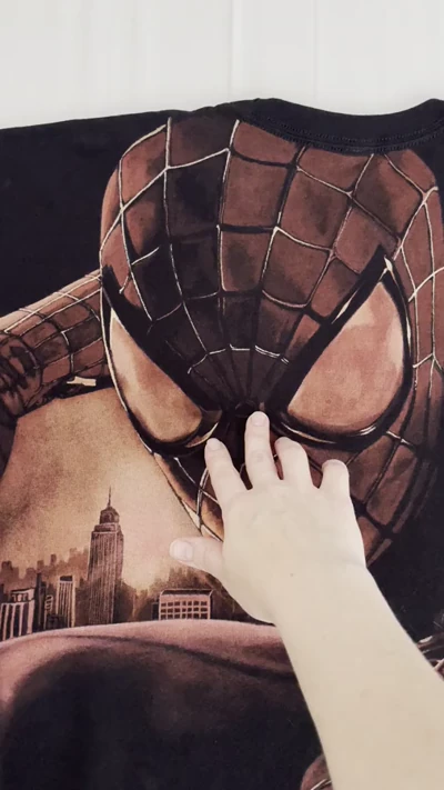 Video showing the large hand-painted Spider-Man bleach art design on the back of a black T-shirt