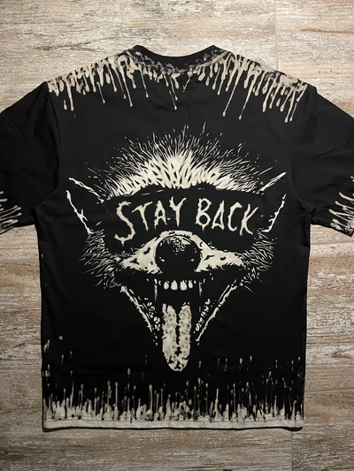 Black raccoon bleach art shirt back view with Stay Back text and dripping bleach details