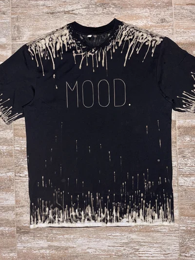 Front view of black bleach art shirt with MOOD text print and alternative streetwear style