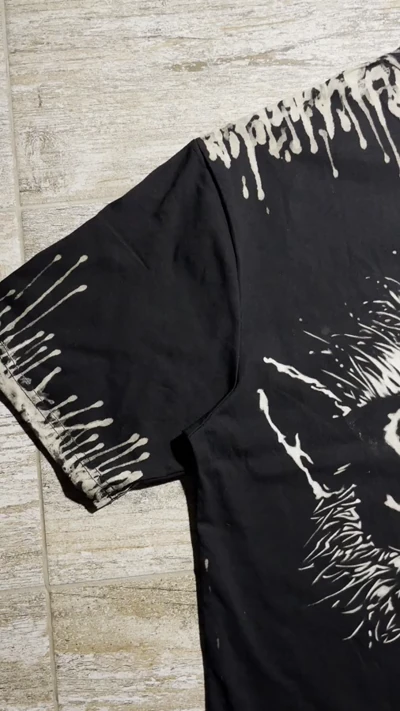 Video of handmade raccoon bleach art shirt with Stay Back back print and grunge bleach details