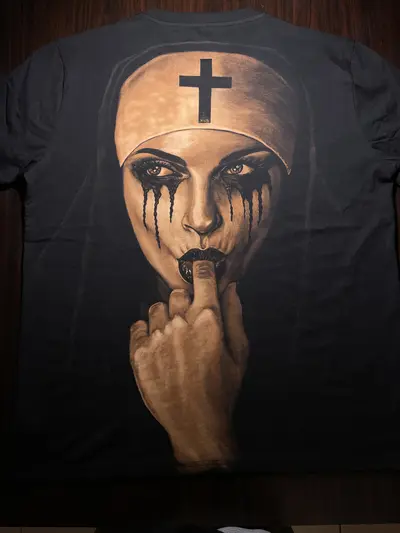 Full back view of hand painted bleach art T-shirt with nun illustration