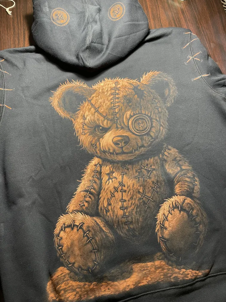 Bleach art teddy bear illustration covering the back of a fleece hoodie