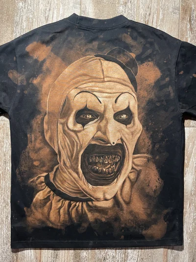 Full back view of a black Terrifier T-shirt with a large hand-painted Art the Clown portrait