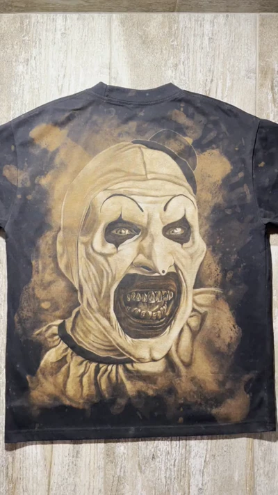 Video showing the full back of a Terrifier T-shirt with a large hand-painted Art the Clown portrait