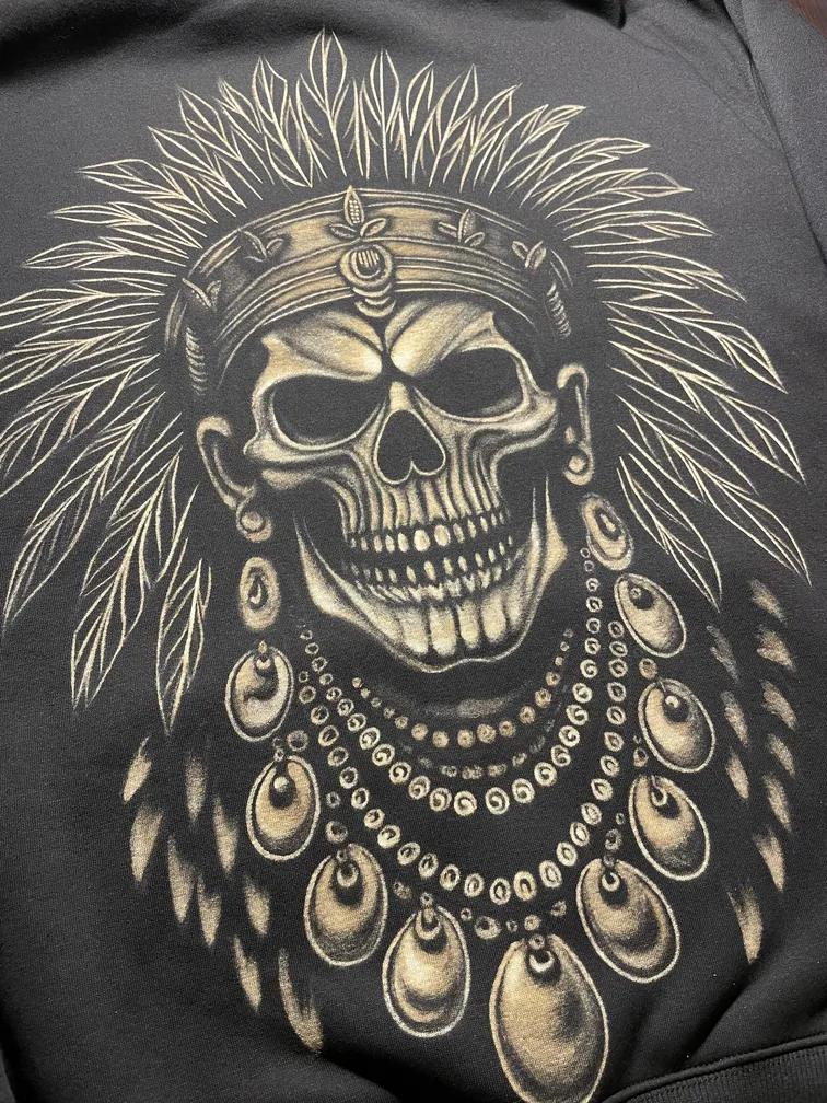 Tribal skull bleach art illustration covering the back of a fleece hoodie